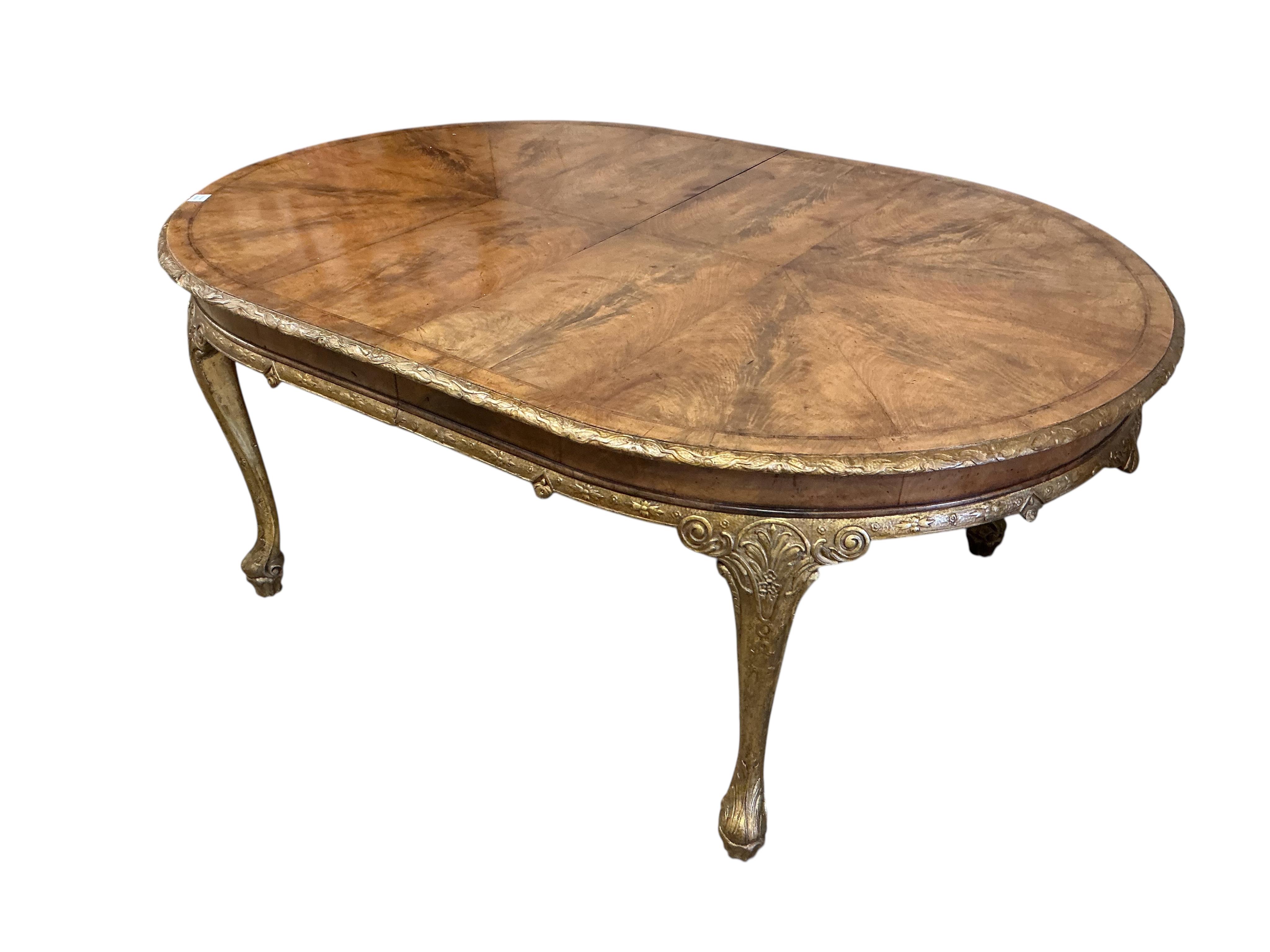 A George I style banded parcelgilt walnut extending dining table, width 300cm extended, one spare leaf, depth 120cm, height 76cm